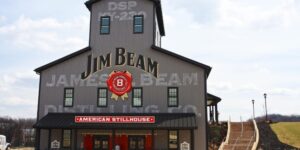 Front view of Jim Beam distillery with logo and entrance stairs.